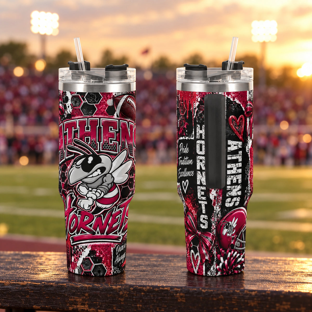 Athens Hornets 40oz stainless steel tumbler, front and back views with hornet mascot and maroon spirit print, on bleachers at a football stadium at golden hour